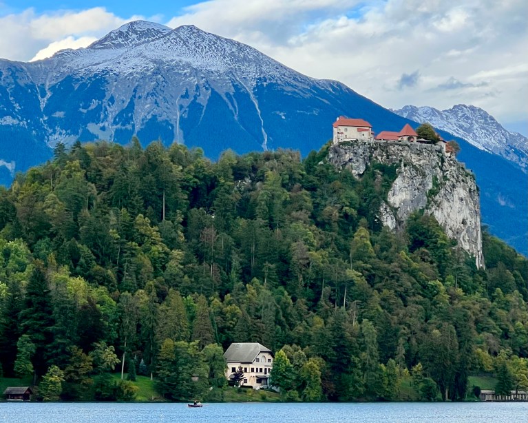 Bled Castle with the Karawanks mountains in the background and Lake Bled in the foreground.