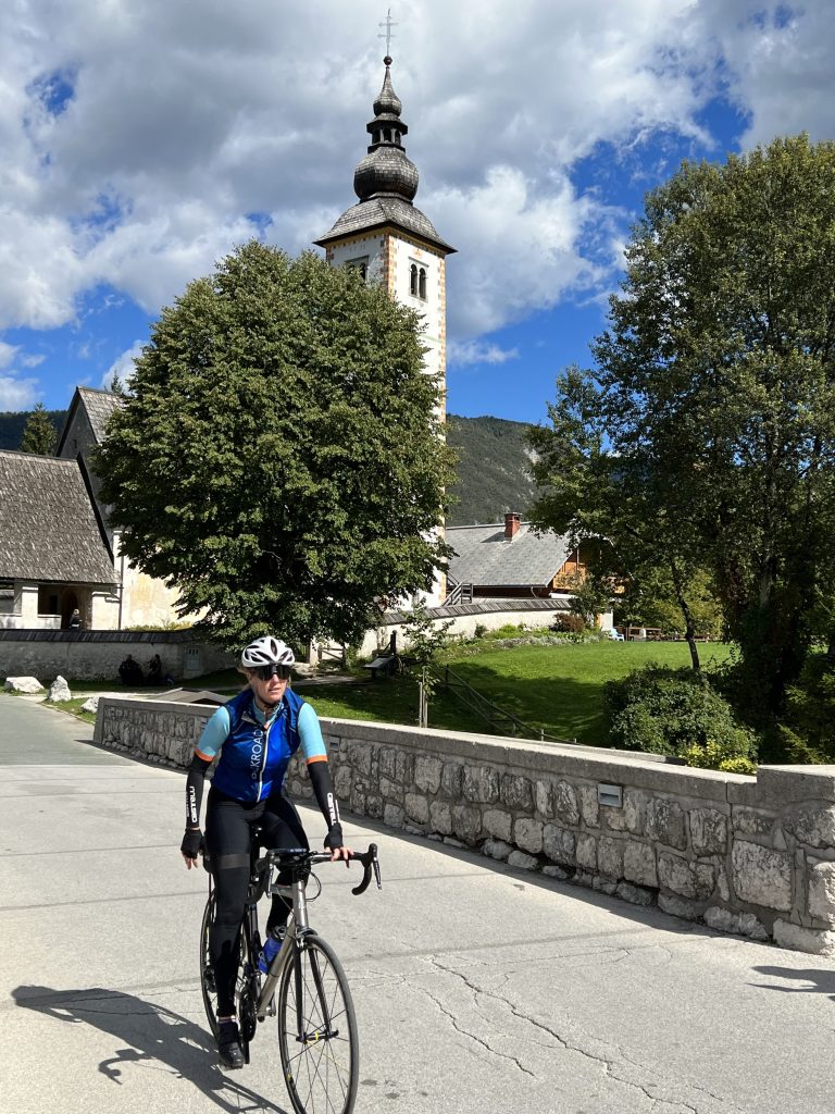 Cycling past St. John The Baptist Church at Bohinj Lake in Slovenia